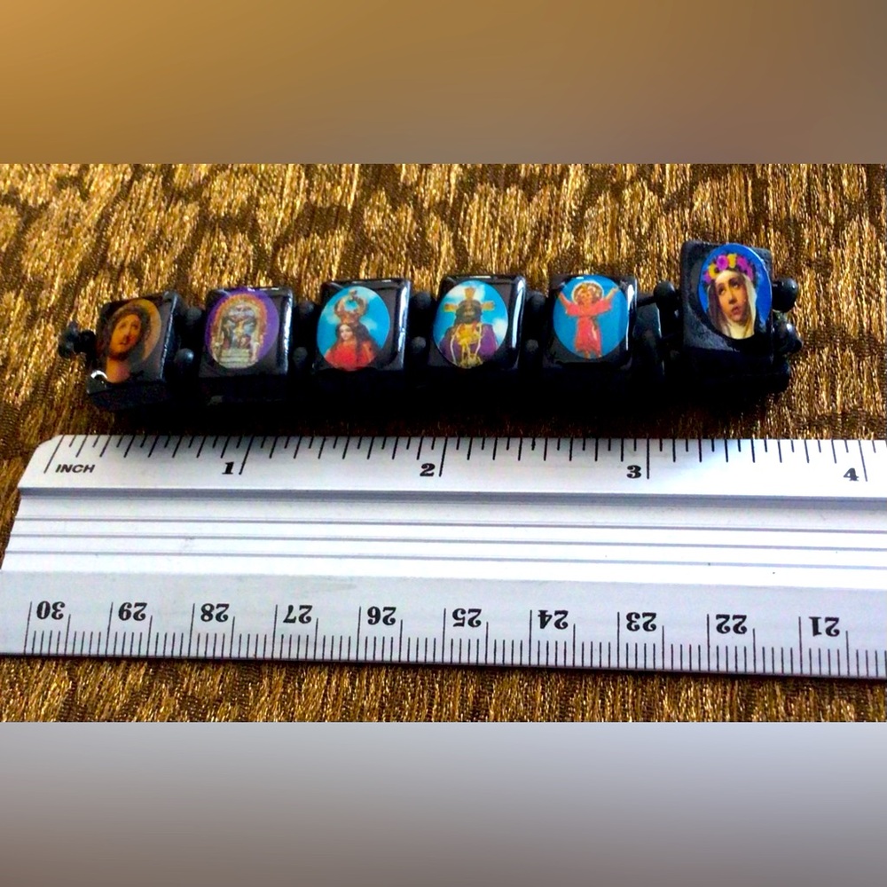 Stretchy bracelet with religious icons.